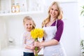 Beautiful girl giving flowers for mothers day