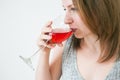 Beautiful girl with a glass of wine at home