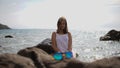 Beautiful girl with glasses in front posing at the camera on the sea background