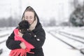 Portrait of a beautiful young woman with a german boxer puppy on a winter walk Royalty Free Stock Photo