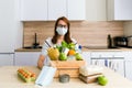 A girl in medical gloves collects a charity donation wooden box with food Royalty Free Stock Photo