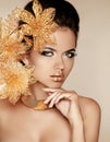 Beautiful Girl With Golden Flowers. Beauty Model Woman Face. Per Royalty Free Stock Photo