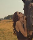 Beautiful girl in a gown with horse Royalty Free Stock Photo