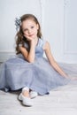 Beautiful girl in gray dress and pointe shoes is posing on the f Royalty Free Stock Photo