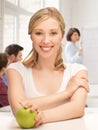 Beautiful girl with green apple at school Royalty Free Stock Photo