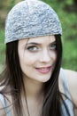 Beautiful girl with green eyes in city park. Woman beauty face portrait Royalty Free Stock Photo