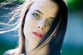 Beautiful girl with green eyes in city park. Woman beauty face portrait Royalty Free Stock Photo