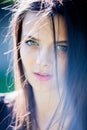 Beautiful girl with green eyes in city park. Woman beauty face portrait Royalty Free Stock Photo