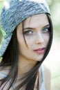 Beautiful girl with green eyes in city park. Woman beauty face portrait Royalty Free Stock Photo