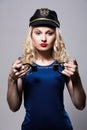 Beautiful girl with handcuffs and a police cap Royalty Free Stock Photo