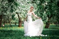 Beautiful girl hands with a branch of a blossoming apple tree. Young beautiful blonde woman in blooming garden. Royalty Free Stock Photo