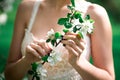 Beautiful girl hands with a branch of a blossoming apple tree. Young beautiful blonde woman in blooming garden. Royalty Free Stock Photo