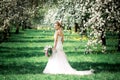 Beautiful girl hands with a branch of a blossoming apple tree. Young beautiful blonde woman in blooming garden. Royalty Free Stock Photo