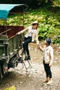 A beautiful girl and a handsome man in military truck. Lovestory. Military vehicle. Military fashion.Carpathian mountains