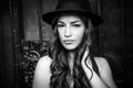 Beautiful girl with hat portrait in the city black and white