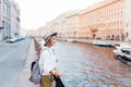 Beautiful girl in a hat smiling at the summer waterfront