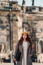 A beautiful girl in a hat stands with a typewriter in the Old city of Dresden.Germany Royalty Free Stock Photo