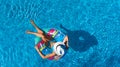 Beautiful girl in hat in swimming pool aerial top view from above, woman relaxes and swims on inflatable ring donut and has fun