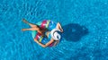 Beautiful girl in hat in swimming pool aerial top view from above, woman relaxes and swims on inflatable ring donut and has fun