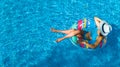 Beautiful girl in hat in swimming pool aerial top view from above, young woman relaxes and swims on inflatable ring donut Royalty Free Stock Photo