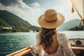 Beautiful girl in a hat on a yacht in the rays of the setting sun, A beautiful tourist woman, seen from the rear, with a sun hat,