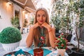 Beautiful girl having lunch in a street cafe in Italy. Royalty Free Stock Photo