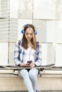 Beautiful girl with headphones and smart phone listening music.