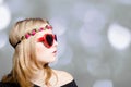 Beautiful girl in heart shaped sunglasses on bokeh Royalty Free Stock Photo