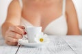 Beautiful girl at her bedroom drinking tea in the morning.