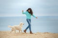 Beautiful girl with her dog near sea Royalty Free Stock Photo