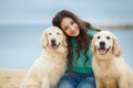 Beautiful girl with her dog near sea Royalty Free Stock Photo