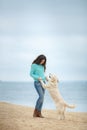 Beautiful girl with her dog near sea Royalty Free Stock Photo