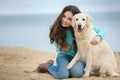 Beautiful girl with her dog near sea Royalty Free Stock Photo