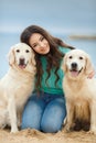 Beautiful girl with her dog near sea Royalty Free Stock Photo