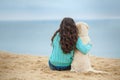 Beautiful girl with her dog near sea Royalty Free Stock Photo