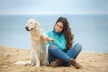 Beautiful girl with her dog near sea Royalty Free Stock Photo