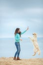 Beautiful girl with her dog near sea Royalty Free Stock Photo