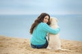 Beautiful girl with her dog near sea Royalty Free Stock Photo