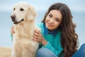 Beautiful girl with her dog near sea Royalty Free Stock Photo
