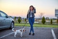 Beautiful girl with her friend Jack Russell dog walking in the park Royalty Free Stock Photo