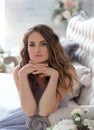 A beautiful girl with her hands folded near her face, in a lavender color dress Royalty Free Stock Photo