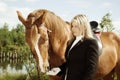 Beautiful girl and her handsome horse Royalty Free Stock Photo