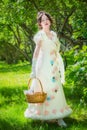 Beautiful girl in an historical bride dress with a wicker basket in her hands Royalty Free Stock Photo