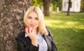 Beautiful girl holding an apple near the tree