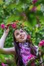 Beautiful girl holding a branch of apple blossoms.