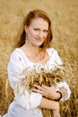 Beautiful girl holding a bunch of wheat ears Royalty Free Stock Photo