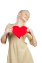 Beautiful girl holding heart in arms. Royalty Free Stock Photo