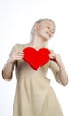 Beautiful girl holding heart in arms Royalty Free Stock Photo