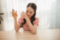 Beautiful girl holding perfume in her hands and applying it Royalty Free Stock Photo