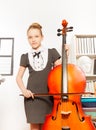 Beautiful girl holding and playing violoncello